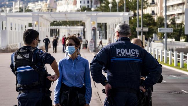 Police officers patrol the Promenade des Anglais in Nice, France. The country began a four-week lockdown on October 30, shuttering non-essential businesses and limiting the reasons people can leave their homes. Picture: Getty Images