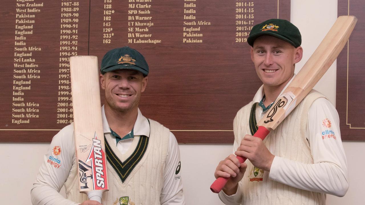 David Warner and Marnus Labuschagne pose in front of their names on the honour board. Photo: Mark Kolbe/Getty Images.