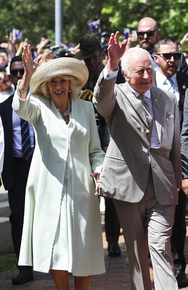 King Charles III and Queen Camilla wave as they walk during a visit to St. Thomas's Anglican Church. Picture: Getty