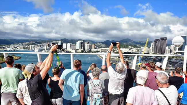 Passengers aboard the Norwegian Jewel cruise ship rejoice at seeing land of Honolulu, Hawaii, after spending several days at sea being refused entry at multiple ports over coronavirus fears. Picture: Tom Huntley