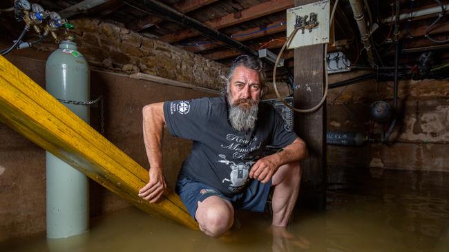 Beefy Kovacs, 51, is helping to pump out water from underneath the Mannum Hotel. Picture: Ben Clark