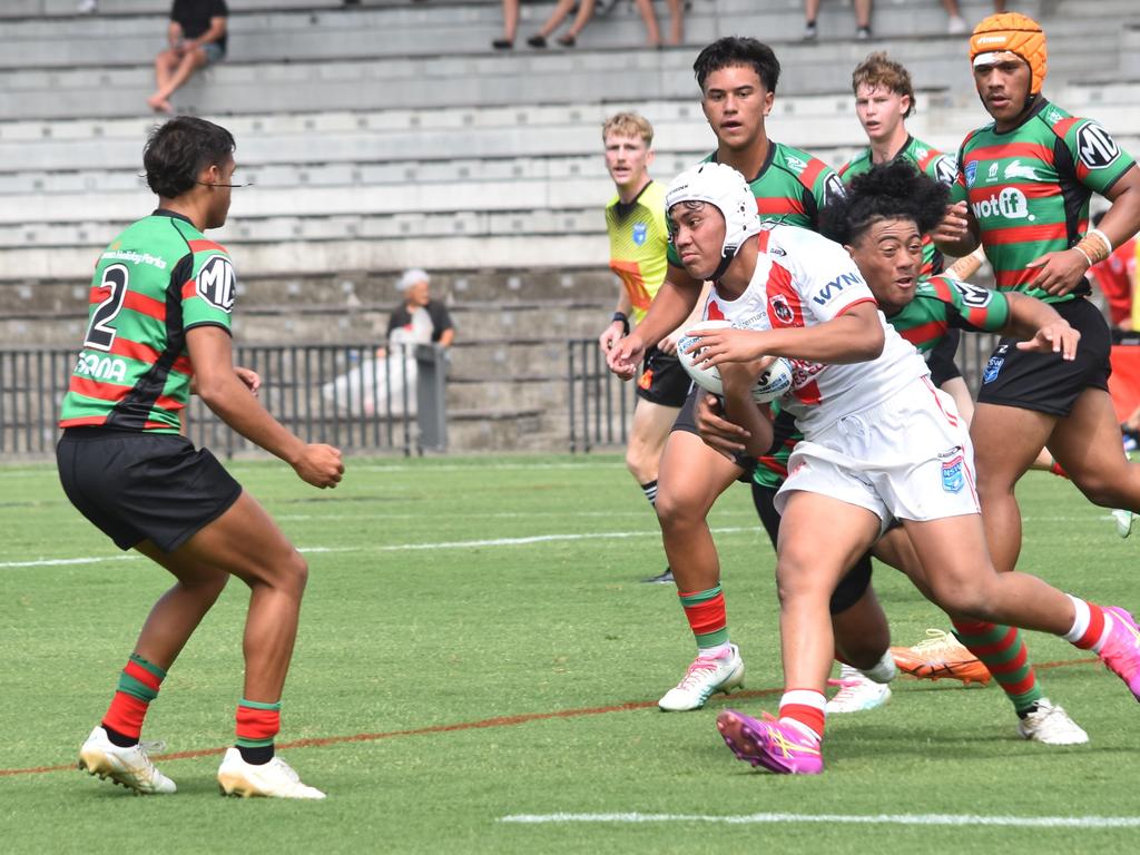 Lino Tamaseu is tackled by Jahzelle Lokeni as Robert Simms watches on. Picture: Sean Teuma