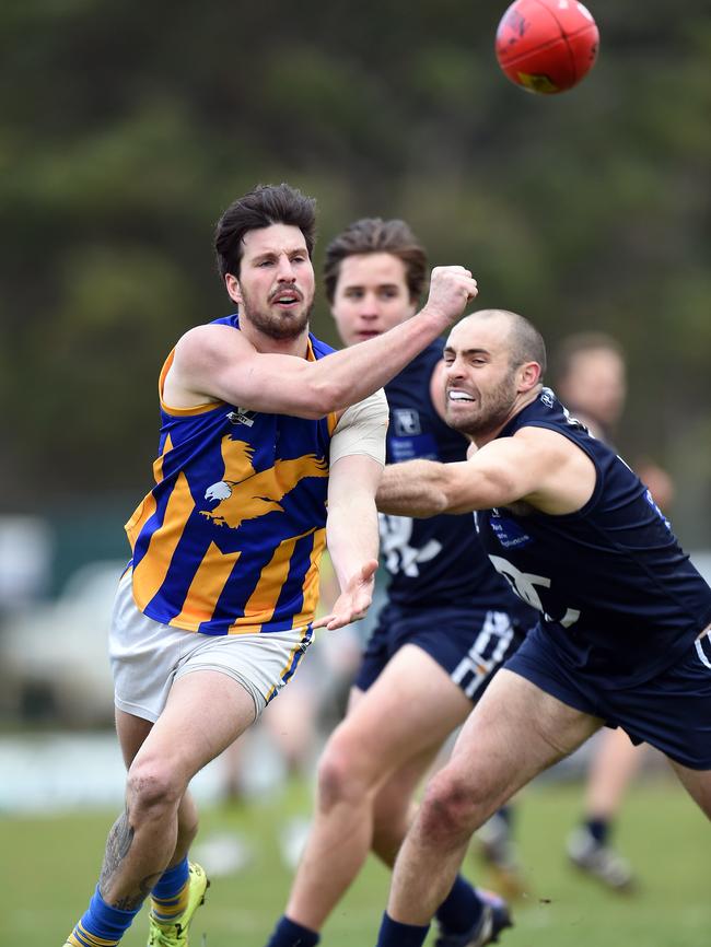 Somerville’s Adrian Speedy fires off a handball in front of Rosebud’s Rhys Bancroft. Picture: Jason Sammon.