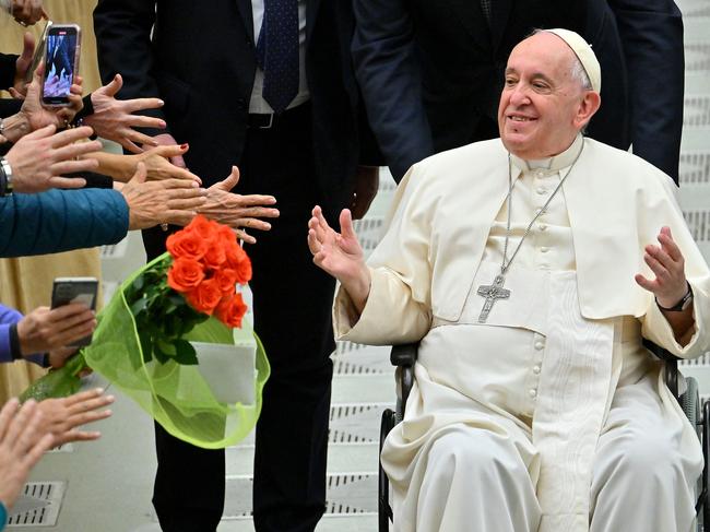 (FILES) In this file photo taken on December 28, 2022 Pope Francis salutes the pilgrims during the weekly general audience in Paul VI hall at the Vatican on December 28, 2022. - Pope Francis marks 10 years as head of the Catholic Church on Monday, hugely popular but facing internal dissent after a decade of reform, even if he has not questioned basic doctrine. (Photo by Filippo MONTEFORTE / AFP)