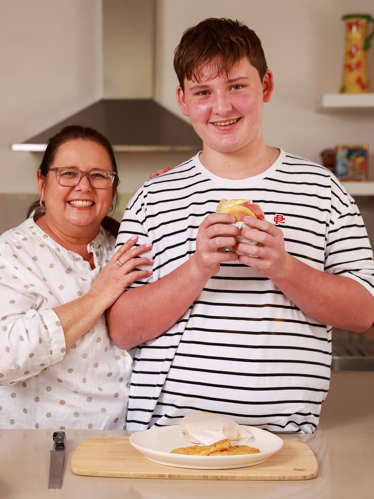 Michelle Southan with her son Xavier Southan, 13, trying her homemade bacon and egg muffin. Picture: Justin Lloyd