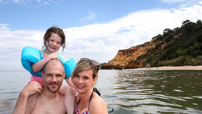 Half Moon Bay Beach is perfect for families like Richard Buck and Isabel Watts with daughter Minnie. Picture: Ian Currie