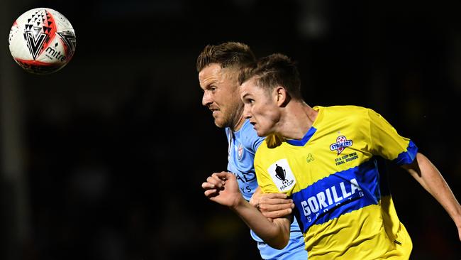 Scott Jamieson of Melbourne City (back) and Zac Maltby of the Strikers compete for the ball. Picture: AAP