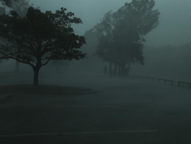 A man runs for cover as the storm hits at Iron Cove Bay. Picture: Rohan Kelly