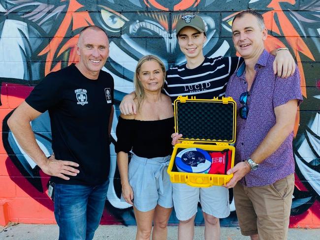 Scott Whimpey from First Aid Accident and Emergency presents Tyler Newman, and his parents Tim and Kerry, with a defibrillator. Picture: First Aid Accident and Emergency