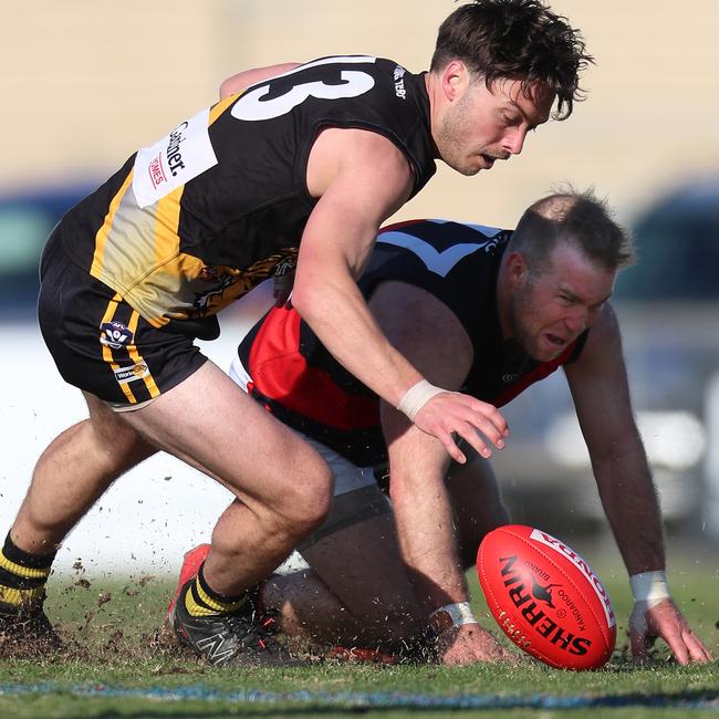 Boisdale-Briagolong’s Mathew Simmonds battles with Wy Yung’s Dylan Wilson for possession.