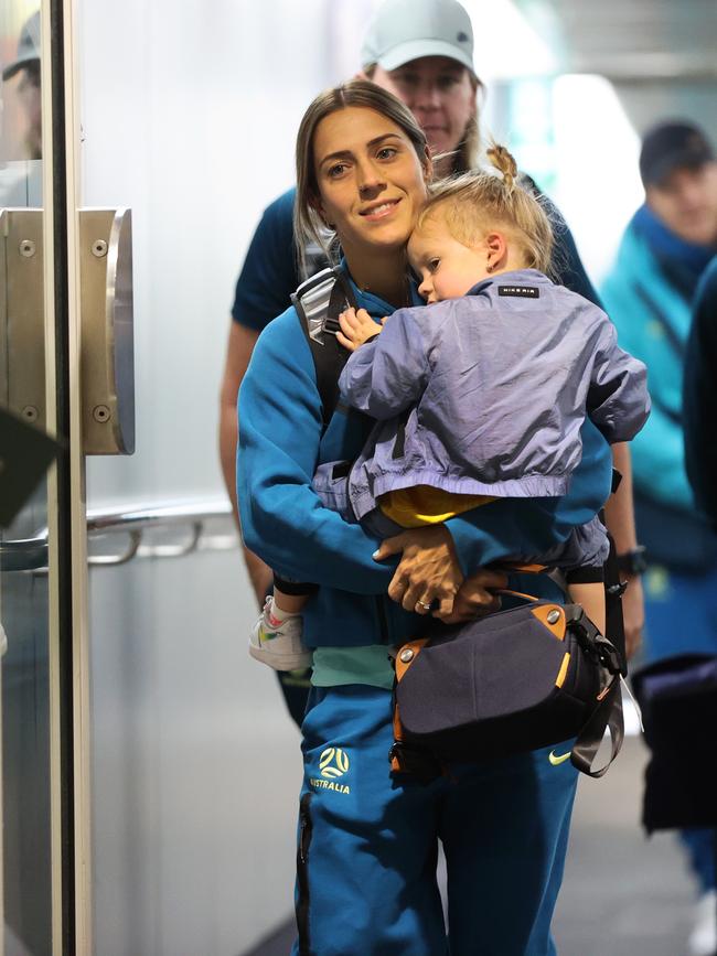 Katrina Gorry and Harper at Brisbane airport after the win over Denmark. Picture: Nigel Hallett