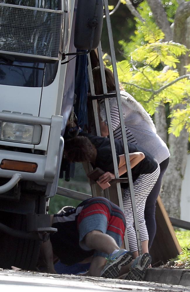 Thorburn helps the men get the belongings into the truck.