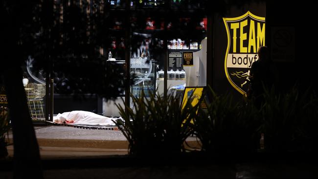 The body of Omar Zahed lying near the entrance to the gym, covered by a white sheet. Picture: Toby Zerna