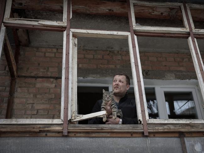 A man holds a cat in a house damaged by a missile attack in Vyshhorod, Ukraine. Picture: Getty Images