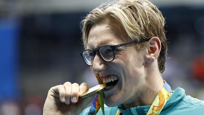 Mack Horton bites his Olympic gold medal. Picture: AFP Photo/Odd Andersen