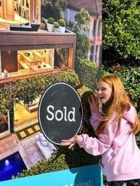 Pixie Curtis with the sold sign outside the home. Picture: Instagram