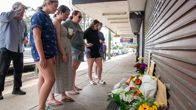 Community members have laid flowers at the Buzzy Bee Burger House after the alleged double murder. Picture Thomas Lisson