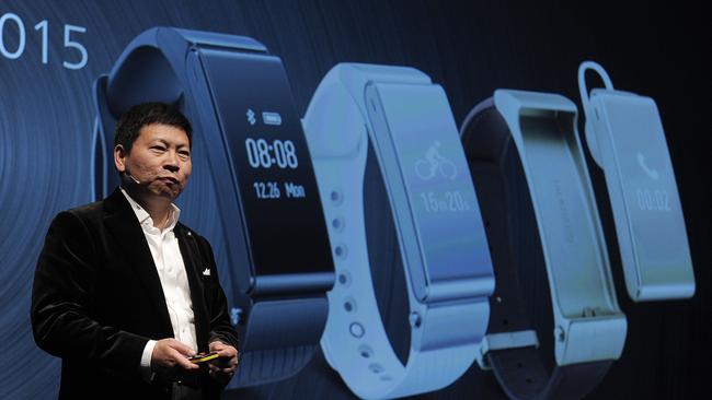 Huawei's Consumer Business Group chief executive officer Richard Yu presents his company's new device "Talkband B2" during the Mobile World Congress.