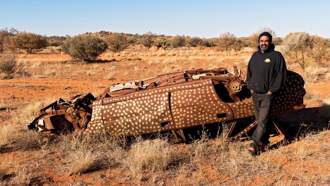 Robert Fielding with another of his car body artworks, On Country. Picture: Courtesy the artist and Mimili Maku Arts