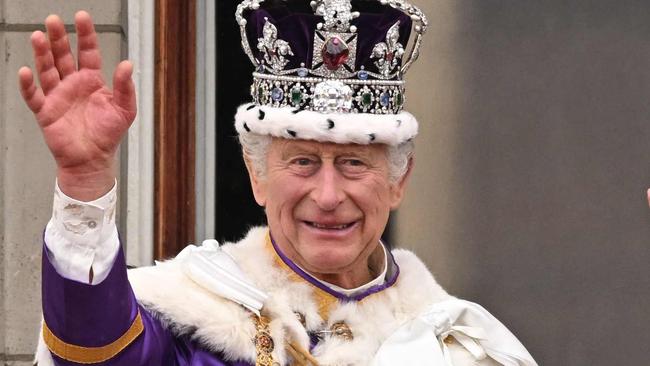 -- AFP PICTURES OF THE YEAR 2023 --  Britain's King Charles III wearing the Imperial state Crown, and Britain's Queen Camilla wearing a modified version of Queen Mary's Crown wave from the Buckingham Palace balcony after viewing the Royal Air Force fly-past in central London on May 6, 2023, after their coronations.. The set-piece coronation is the first in Britain in 70 years, and only the second in history to be televised. Charles will be the 40th reigning monarch to be crowned at the central London church since King William I in 1066. (Photo by Oli SCARFF / AFP) / AFP PICTURES OF THE YEAR 2023