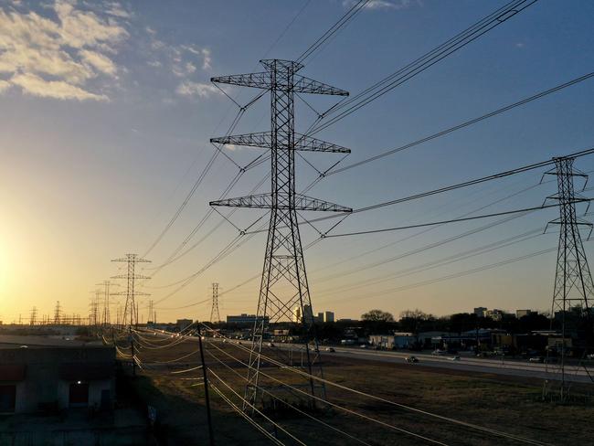 HOUSTON, TEXAS - FEBRUARY 21: A view of high voltage transmission towers on February 21, 2021 in Houston, Texas. Millions of Texans lost power when winter storm Uri hit the state and knocked out coal, natural gas and nuclear plants that were unprepared for the freezing temperatures brought on by the storm. Wind turbines that provide an estimated 24 percent of energy to the state became inoperable when they froze.   Justin Sullivan/Getty Images/AFP == FOR NEWSPAPERS, INTERNET, TELCOS & TELEVISION USE ONLY ==