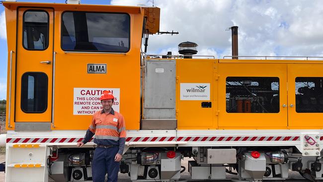 Senior Project Engineer Chris Weight with Wilmar Sugar and Renewables’ new $2 million, 26-tonne locomotive Alma, which has been delivered to Inkerman Mill in the Burdekin. The Alma is one of four new cane trains that will be delivered ahead of the 2024 sugar-cane harvest in North Queensland. The locomotives are modelled on the Brisbane, which Wilmar designed and built from the ground up and launched last year. Wilmar’s eight sugar factories were expected to process a total of 15.59 million tonnes of cane this season, up on last year’s total of 15.02m tonnes. Picture: Supplied