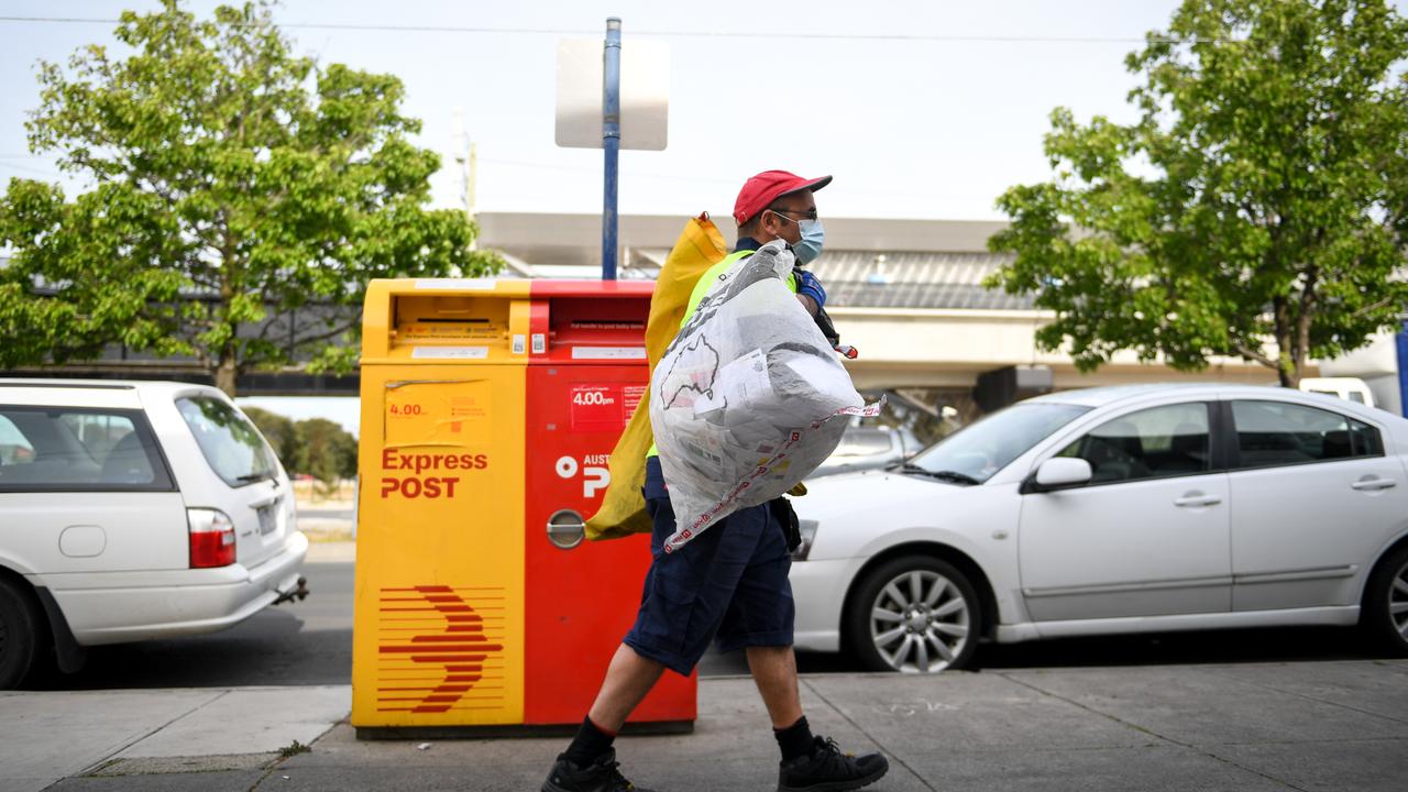 An Australia Post employee completes a pick-up in Spring Street, Reservoir last week. Picture: NCA NewsWire / Penny Stephens