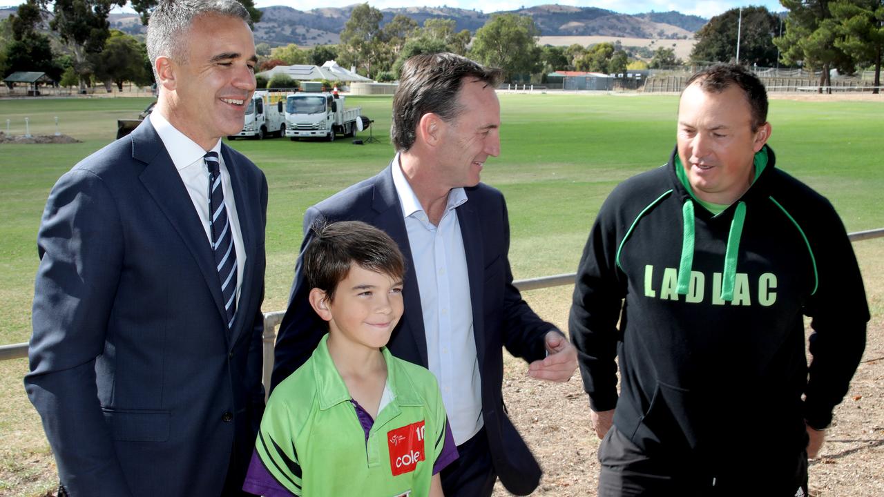 Lyndoch Recreation Park Barossa Valley Way, Lyndoch. – Premier Peter Malinauskas, and AFL CEO Andrew Dillon, with local Little Athletics coach, Morgan Heggie (0435588739), and his son Cameron, 10, re: Gather Round heading to the Barossa in 2025. 8 April 2024. Picture Dean Martin