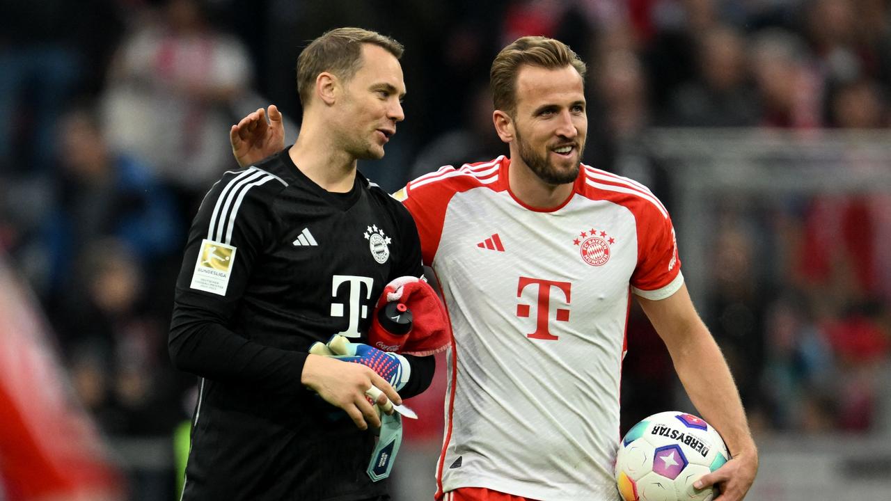 Neuer and Kane celebrate the big win. (Photo by Christof STACHE / AFP)