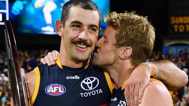 ADELAIDE, AUSTRALIA - APRIL 01:Rory Sloane of the Crows kisses Taylor Walker of the Crows holding the Showdown Shield  after the round three AFL match between Port Adelaide Power and Adelaide Crows at Adelaide Oval, on April 01, 2023, in Adelaide, Australia. (Photo by Mark Brake/Getty Images)