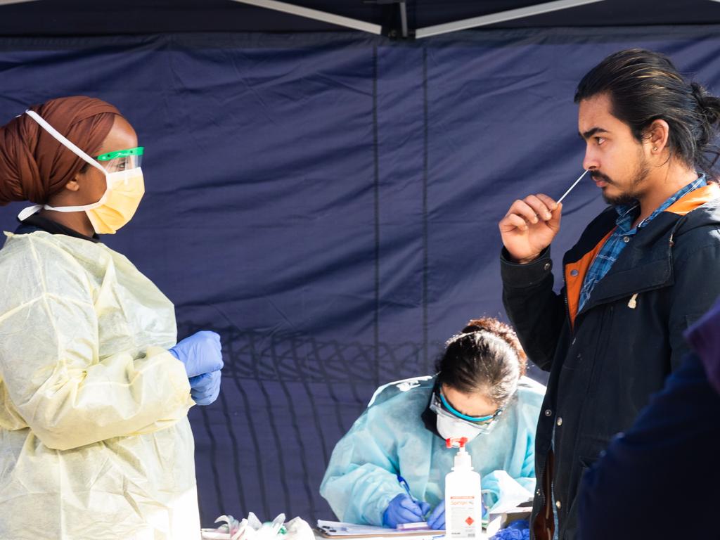 A man conducts a COVID-19 test by inserting a swab in his nose, under the guidance of a member of the testing team at a pop-up testing site in the suburb of Broadmeadows in Melbourne. Picture: Asanka Ratnayake/Getty Images