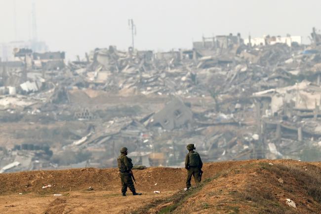 Israeli soldiers patrol along the Israel-Gaza border