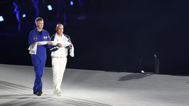 John McFall, British Surgeon and former Paralympian (L), carries the Paralympic flag onto the stage prior to the declaration of the games during the opening ceremony. (Photo by Naomi Baker/Getty Images)