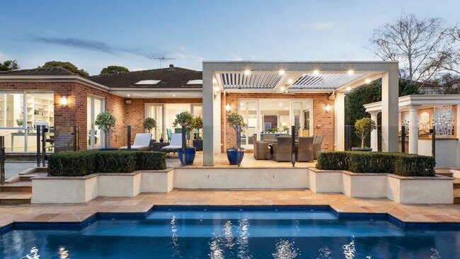 The sandstone-paved entertaining area, with a built-in barbecue, sits next to the solar-heated pool.