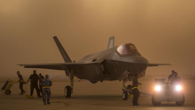 Lockheed Martin and Royal Australian Air Force maintenance personnel prepare to tow an Australian F-35A aircraft during a sudden dust storm at Luke Air Force Base, Arizona, USA. Picture: Supplied