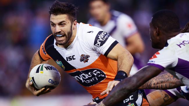 SYDNEY, AUSTRALIA - APRIL 17: James Tedesco of the Tigers takes on the defence during the round seven NRL match between the Wests Tigers and the Melbourne Storm at Leichhardt Oval on April 17, 2016 in Sydney, Australia. (Photo by Matt King/Getty Images)