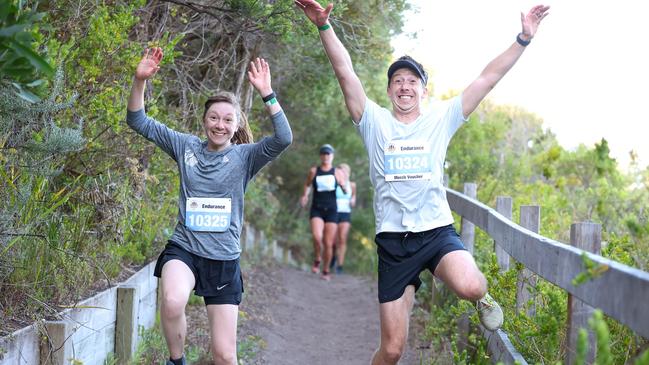 Runners jump for joy during the Portsea Bay to Surf run.