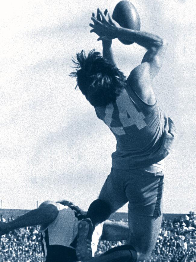 Footballer Rick Davies marking over Chris Natt. SANFL football - Port Adelaide Magpies vs Sturt Grand Final match 1976. a/ct with /Football/SANFL Picture: File Photo