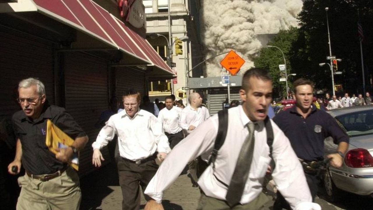 Mr Cooper (left) is pictured in this famous photo during the 9/11 catastrophe. Picture: AP