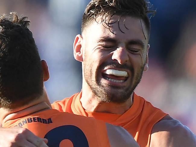 Stephen Coniglio (right) and Josh Kelly of the Giants react after the final siren during the Round 4 AFL match between the Geelong Cats and the GWS Giants at GMHBA Stadium in Geelong, Saturday, April 13, 2019. (AAP Image/Julian Smith) NO ARCHIVING, EDITORIAL USE ONLY