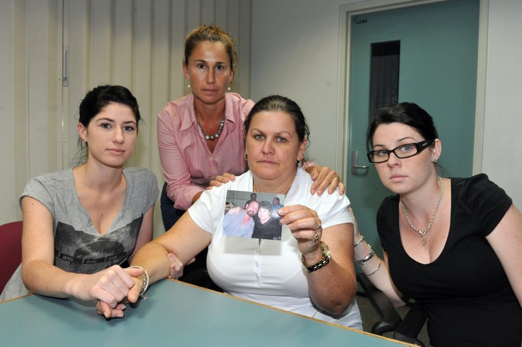 MISSING MAN: Julie Stevenson holds a photo of her missing husband Paul Stevenson and is comforted by her niece Amy McLennan, friend Wendy Lowien and daughter Nikki Stevenson. Photo: Scottie Simmonds / NewsMail. Picture: Scottie Simmonds BUN130312LOS4