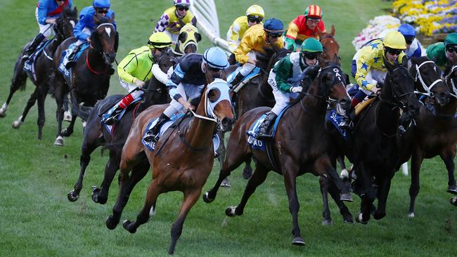 The Cleaner (blue cap) strung out five wide to the first turn in last year’s Cox Plate. Picture: Michael Klein