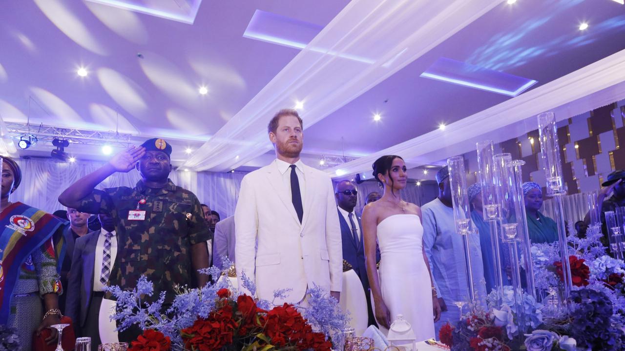 All rise: Harry and Meghan at the dinner. Picture: Getty Images Europe.