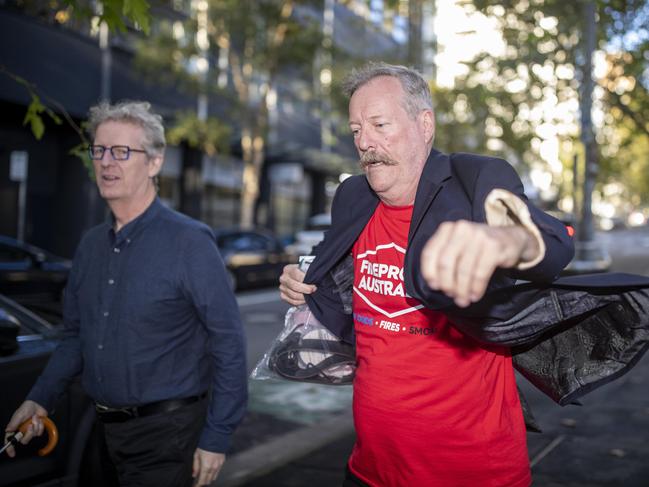 Co-accused Alan Glover (in red shirt), leaving the Surry Hills Police Station in April. Picture: Christian Gilles.