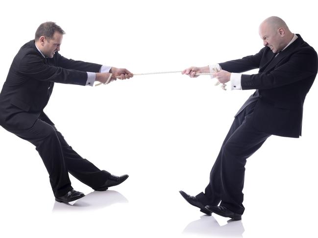 two businessmen in a tug of war isolated on white background tug of war for laurie oakes column on political instability post election 2016