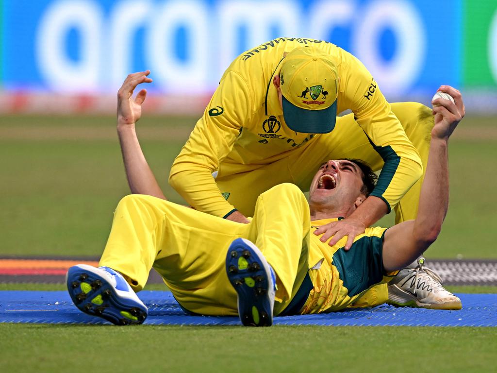 Pat Cummins (R) celebrates with Marnus Labuschagne after taking the catch to dismiss South Africa's Quinton de Kock. Picture: AFP