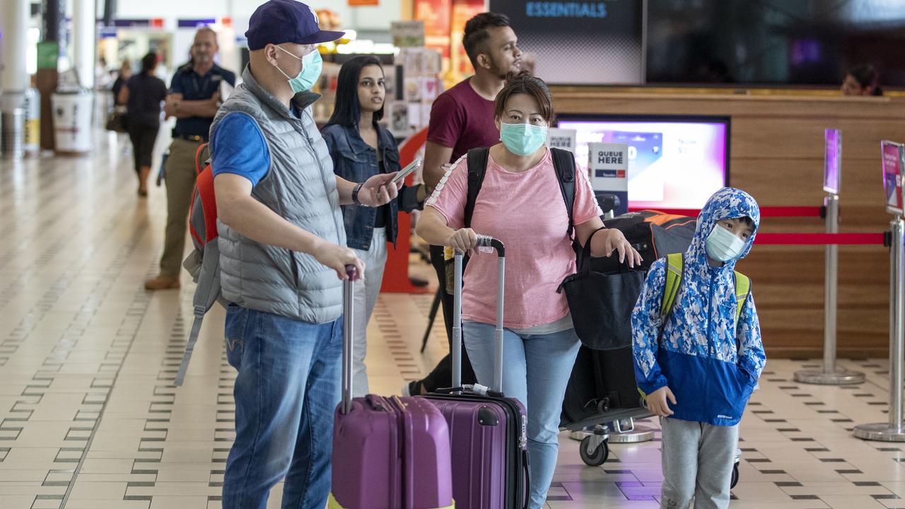 People were seen wearing protective face masks to protect themselves from Coronavirus at Brisbane International Airport. Picture: AAP Image/Glenn Hunt