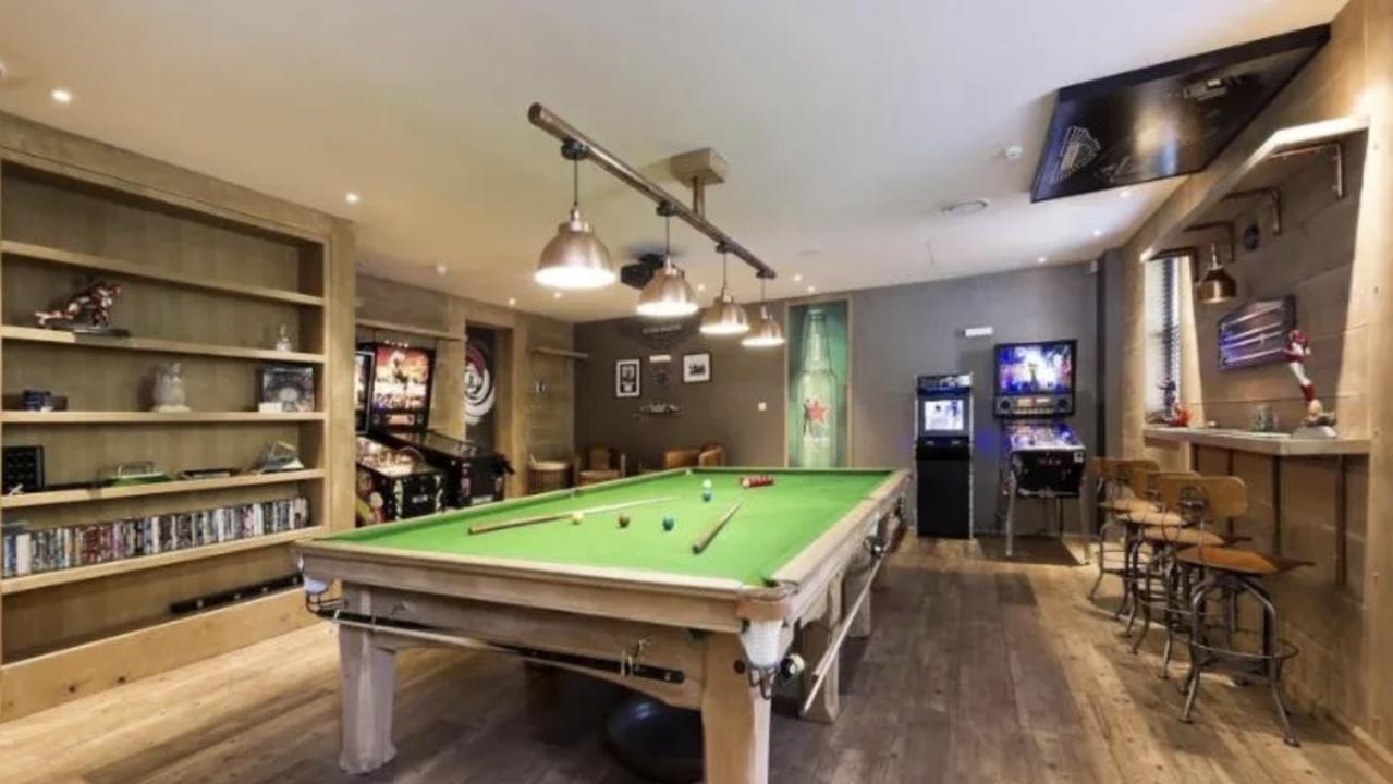 The late pop star’s mancave featuring a bar, pinball machines, pool table and library.