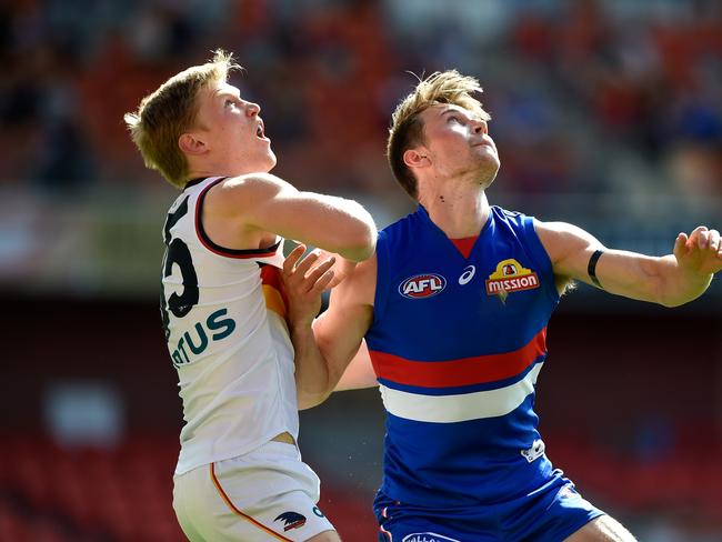 GOLD COAST, AUSTRALIA - AUGUST 16: Fischer McAsey of the Crows competes for the ball against Ryan Gardner of the Bulldogs during the round 12 AFL match between the Western Bulldogs and the Adelaide Crows at Metricon Stadium on August 16, 2020 in Gold Coast, Australia. (Photo by Matt Roberts/AFL Photos/via Getty Images)