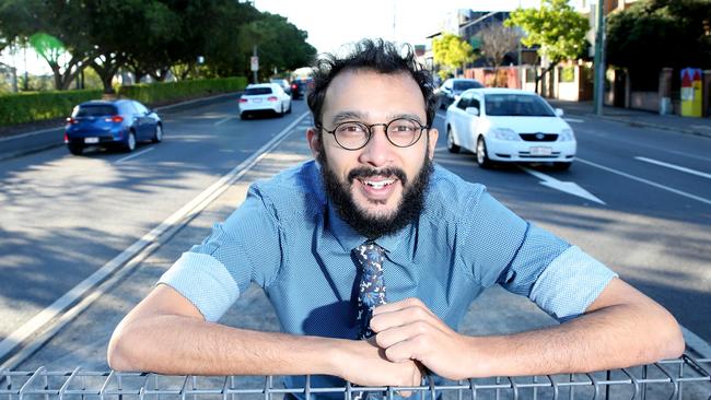 Greens councillor Jonathan Sri has concerns about the Lytton Rd widening project and has created signs opposing the project. Picture: Renae Droop